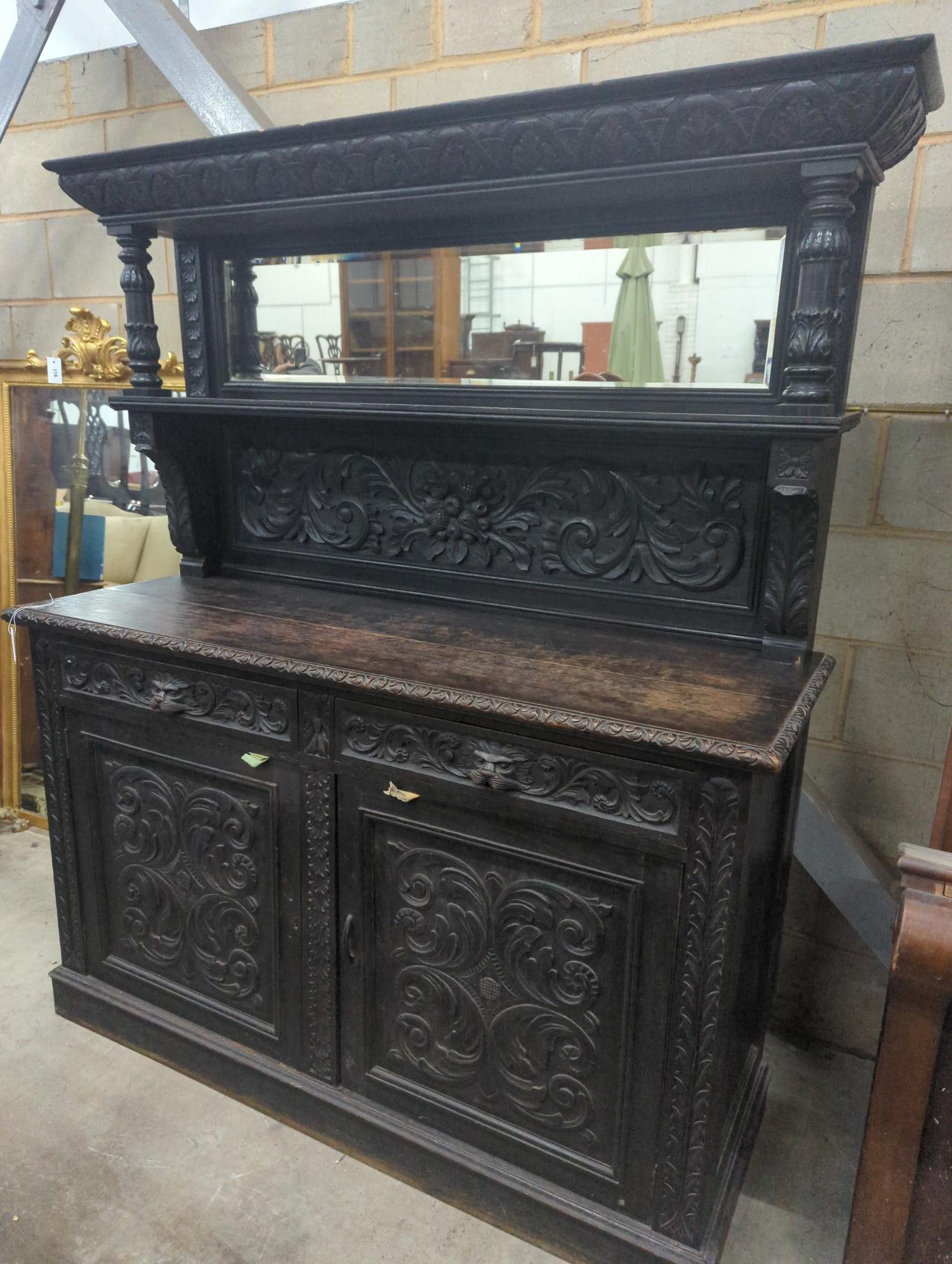 A late 19th century Flemish carved oak mirror back sideboard, width 150cm depth 56cm height 188cm